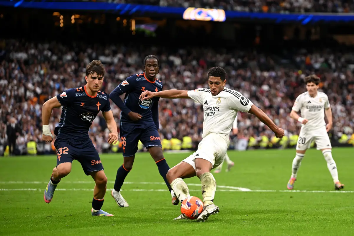 MADRID, SPAIN - MAY 04: Jude Bellingham of Real Madrid shoots whilst under pressure from Javi Rodriguez of Celta Vigo during the LaLiga match between Real Madrid CF and RC Celta de Vigo at Estadio Santiago Bernabeu on May 04, 2025 in Madrid, Spain. (Photo by Denis Doyle/Getty Images)