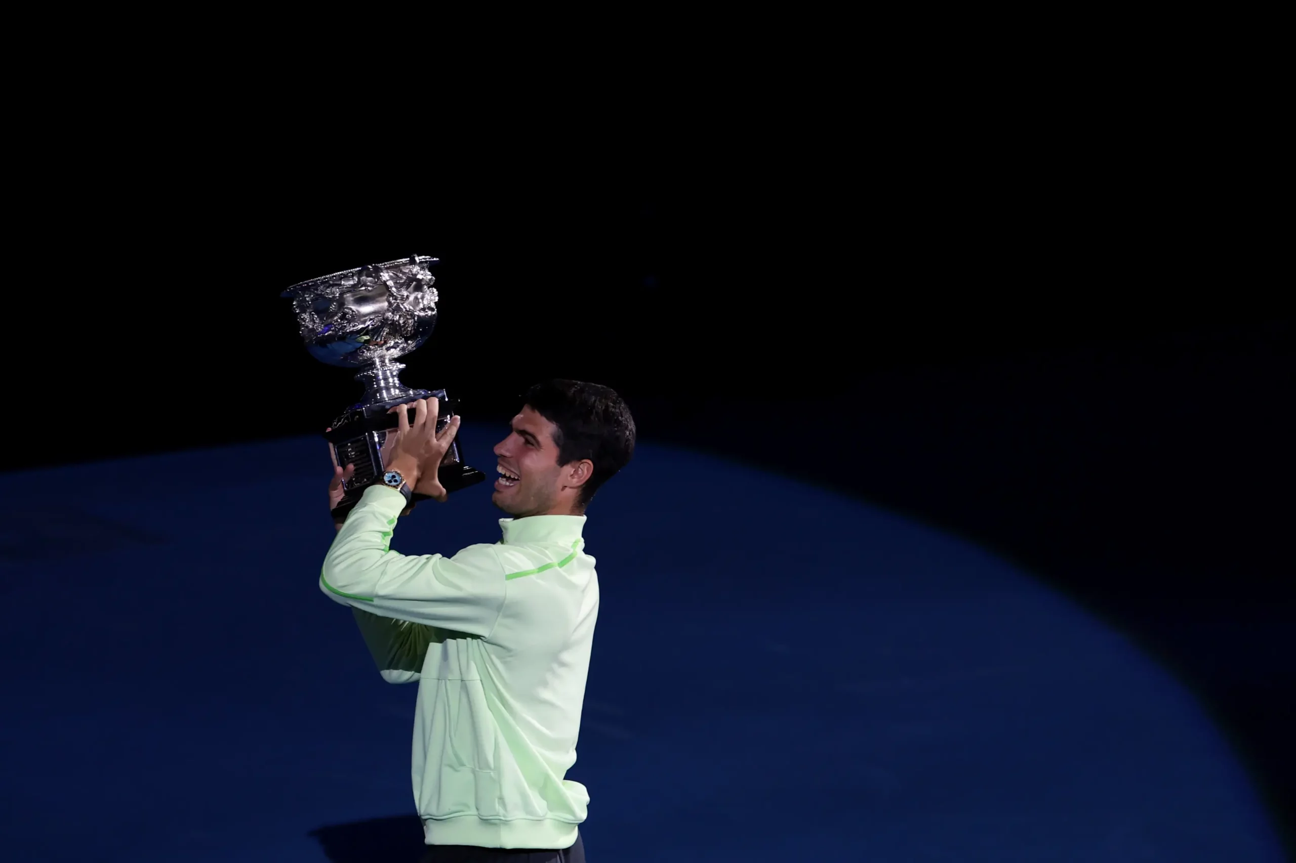 MELBOURNE, AUSTRALIA - FEBRUARY 01: Carlos Alcaraz of Spain acknowledges fans with the Norman Brookes Challenge Cup after the presentation ceremony following the Men's Singles Final against Novak Djokovic of Serbia during day 15 of the 2026 Australian Open at Melbourne Park on February 01, 2026 in Melbourne, Australia. (Photo by Lintao Zhang/Getty Images)