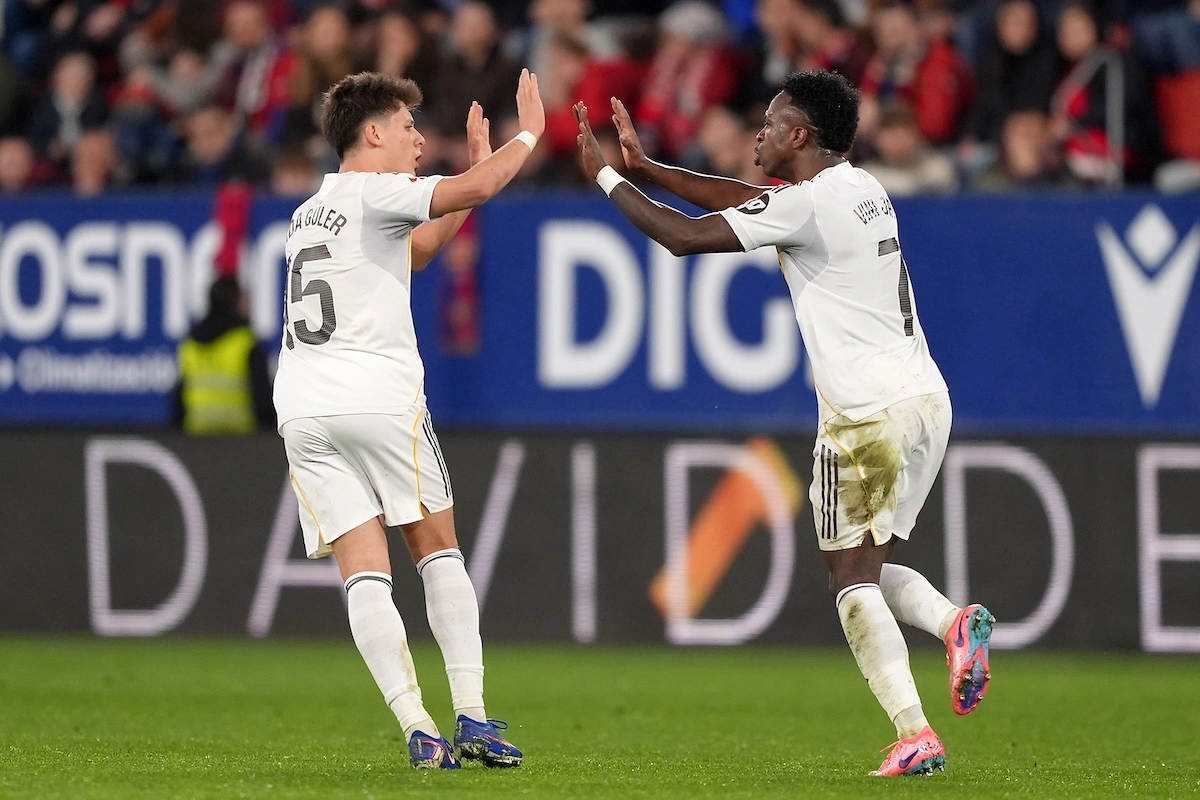 PAMPLONA, SPAIN - FEBRUARY 21: Vinicius Junior of Real Madrid celebrates scoring his team's first goal with teammate Arda Gueler during the LaLiga EA Sports match between CA Osasuna and Real Madrid CF at Estadio El Sadar on February 21, 2026 in Pamplona, Spain. (Photo by Juan Manuel Serrano Arce/Getty Images)