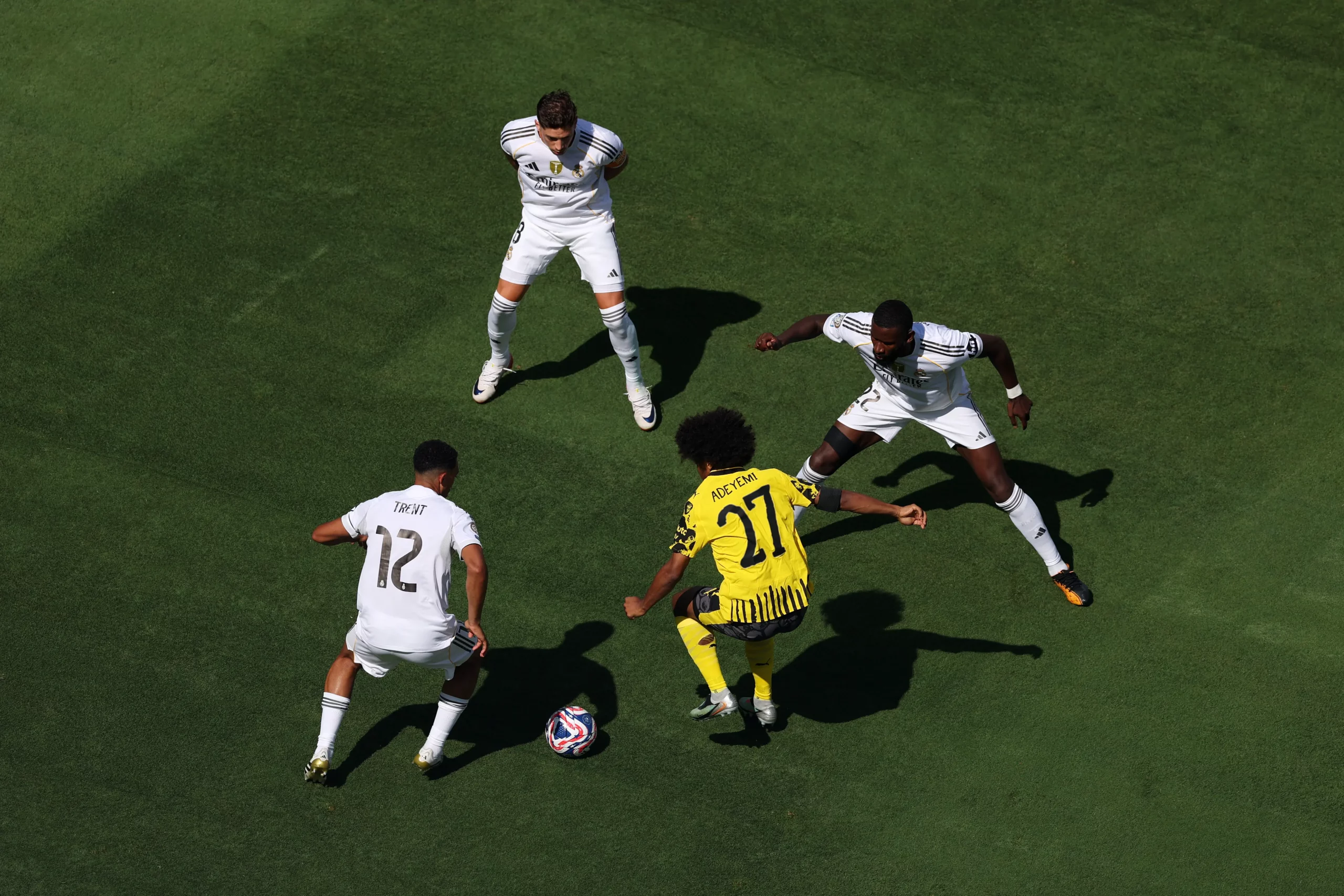 EAST RUTHERFORD, NEW JERSEY - JULY 05: Karim Adeyemi #27 of Borussia Dortmund is challenged by Trent Alexander-Arnold #12 and Antonio Ruediger #22 of Real Madrid during the FIFA Club World Cup 2025 quarter-final match between Real Madrid CF and Borussia Dortmund at MetLife Stadium on July 05, 2025 in East Rutherford, New Jersey. (Photo by Al Bello/Getty Images)