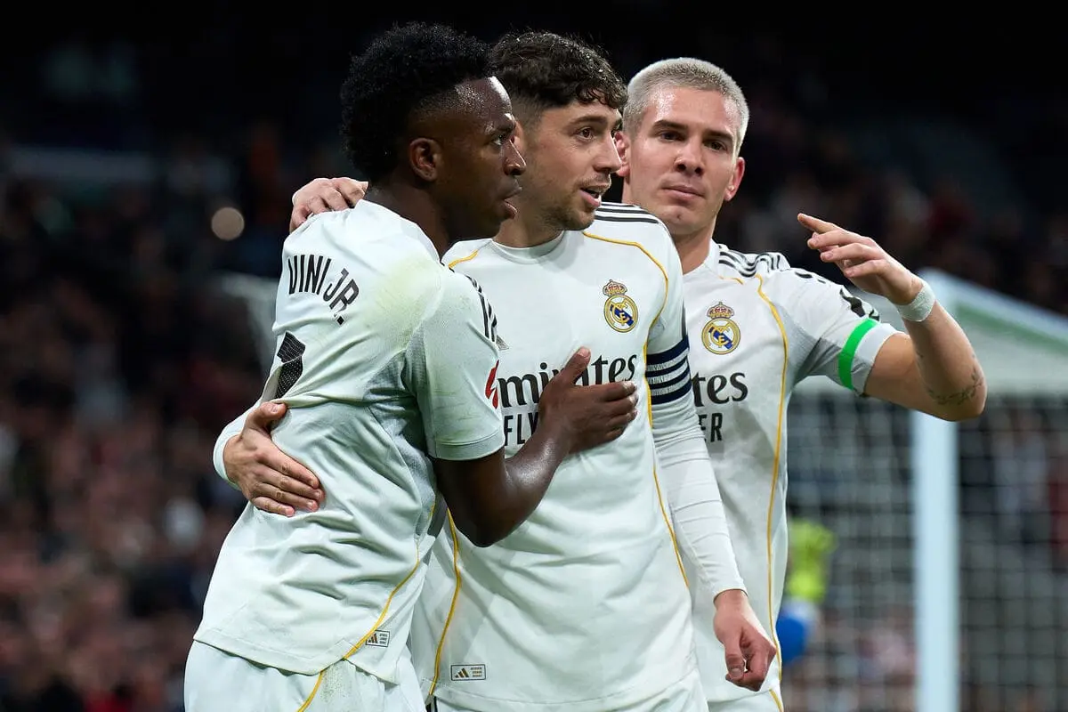 MADRID, SPAIN - FEBRUARY 01: Vinicius Junior of Real Madrid celebrates after scoring his team's first goal with Federico Valverde and Franco Mastantuono during the LaLiga EA Sports match between Real Madrid CF and Rayo Vallecano de Madrid at Estadio Santiago Bernabeu on February 01, 2026 in Madrid, Spain. (Photo by Angel Martinez/Getty Images).