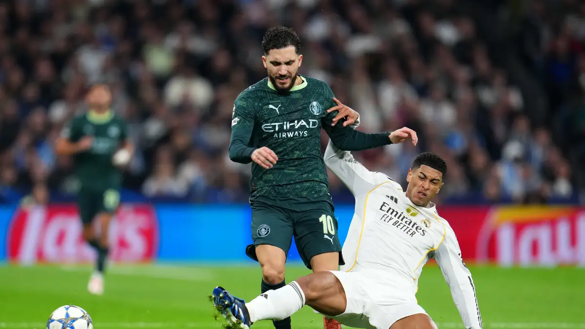 MADRID, SPAIN - DECEMBER 10: Rayan Cherki of Manchester City is challenged by Jude Bellingham of Real Madrid during the UEFA Champions League 2025/26 League Phase MD6 match between Real Madrid C.F. and Manchester City at Estadio Santiago Bernabeu on December 10, 2025 in Madrid, Spain. (Photo by Aitor Alcalde/Getty Images)