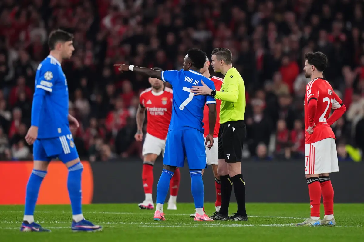 LISBON, PORTUGAL - FEBRUARY 17: Vinicius Junior of Real Madrid speaks to referee Francois Letexier during the UEFA Champions League 2025/26 League Knockout Play-off First Leg match between SL Benfica and Real Madrid C.F. at Estadio do SL Benfica on February 17, 2026 in Lisbon, Portugal. (Photo by Angel Martinez/Getty Images)