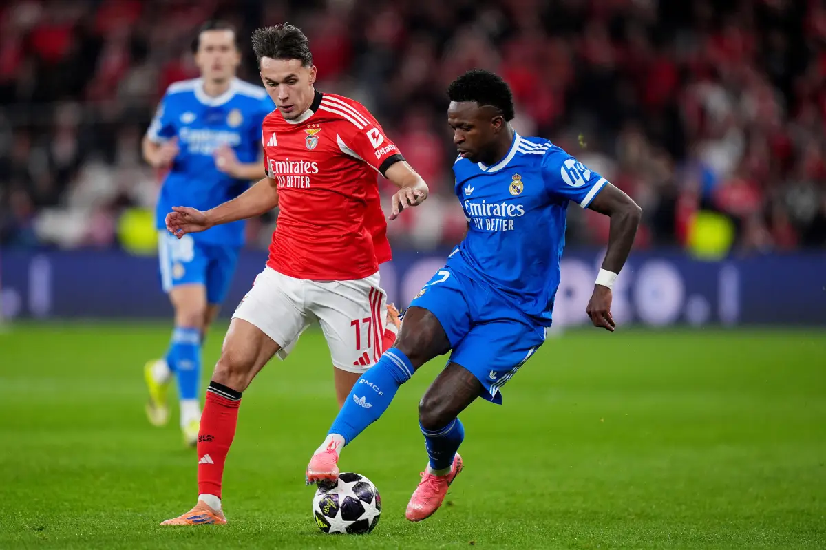 LISBON, PORTUGAL - FEBRUARY 17: Vinicius Junior of Real Madrid is challenged by Amar Dedic of Benfica during the UEFA Champions League 2025/26 League Knockout Play-off First Leg match between SL Benfica and Real Madrid C.F. at Estadio do SL Benfica on February 17, 2026 in Lisbon, Portugal. (Photo by Angel Martinez/Getty Images)