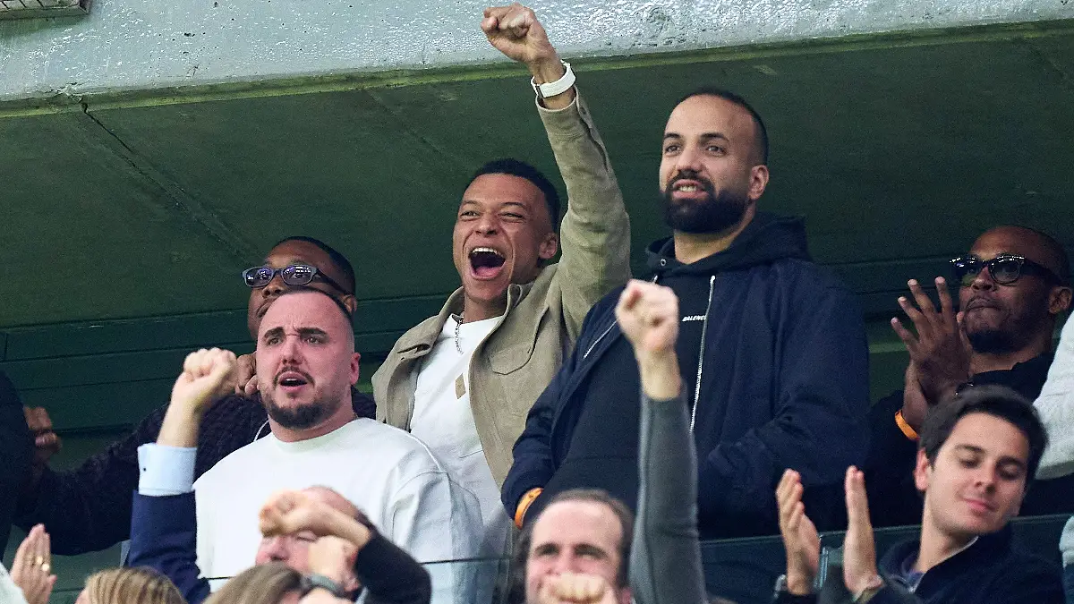 MADRID, SPAIN - MARCH 11: David Alaba and Kylian Mbappe of Real Madrid celebrate their sides first goal by Federico Valverde (not pictured) as they look on from the stands during the UEFA Champions League 2025/26 Round of 16 First Leg match between Real Madrid CF and Manchester City FC at Estadio Santiago Bernabeu on March 11, 2026 in Madrid, Spain. (Photo by Angel Martinez/Getty Images)
