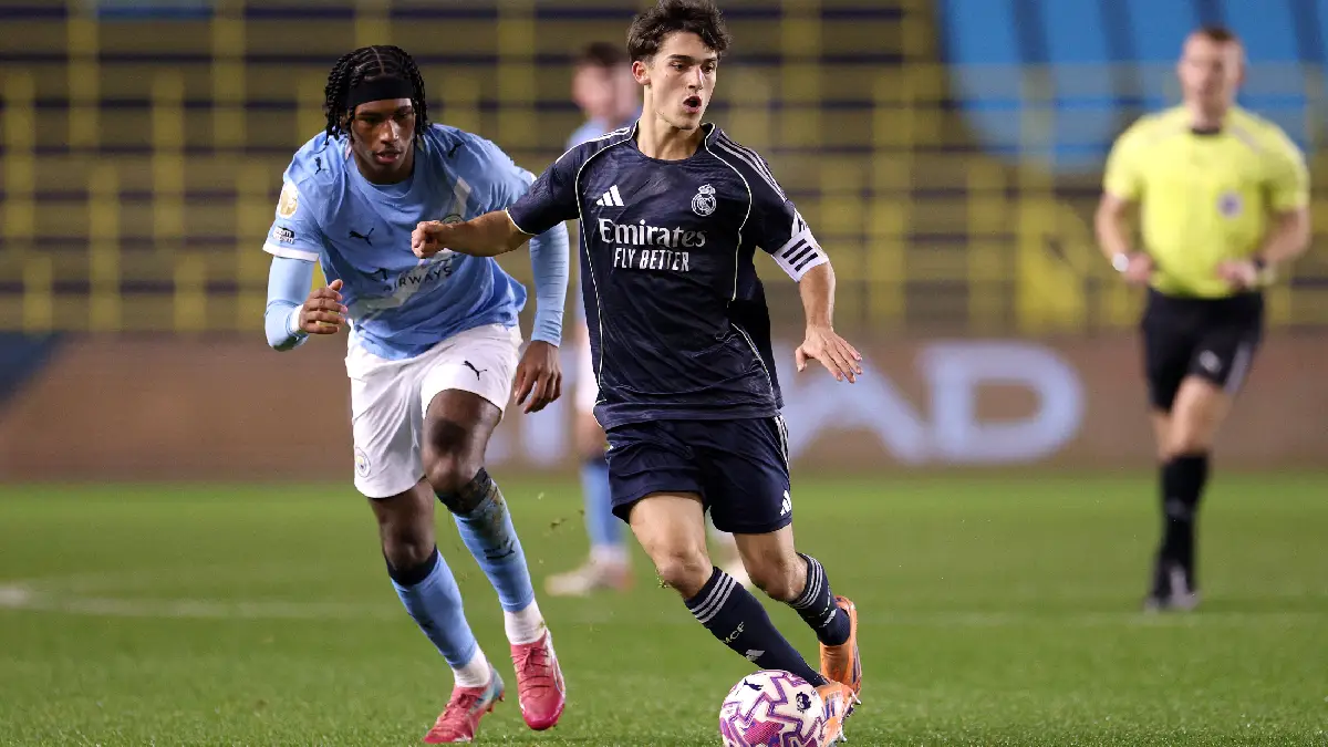 MANCHESTER, ENGLAND - DECEMBER 16: Manuel Angel of Real Madrid is challenged by Reigan Heskey of Manchester City during the Premier League International Cup match between Manchester City and Real Madrid Castilla at Joie Stadium on December 16, 2025 in Manchester, England. (Photo by Ben Roberts Photo/Getty Images)