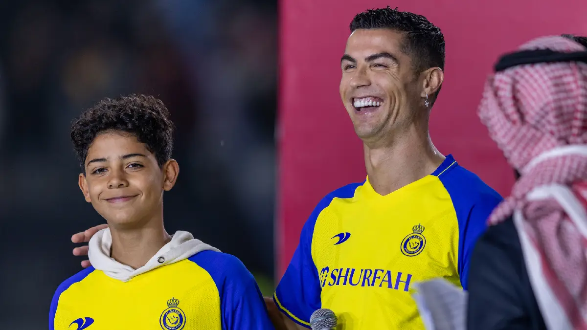 RIYADH, SAUDI ARABIA - JANUARY 03: Cristiano Ronaldo and his son Cristiano Ronaldo Jr greet the crowd during the official unveiling of Cristiano Ronaldo as an Al Nassr player at Mrsool Park Stadium on January 3, 2023 in Riyadh, Saudi Arabia. (Photo by Yasser Bakhsh/Getty Images)