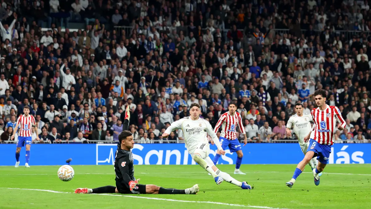 MADRID, SPAIN - MARCH 22: Federico Valverde of Real Madrid scores his team's second goal past Juan Musso of Atletico de Madrid during the LaLiga EA Sports match between Real Madrid CF and Atletico de Madrid at Estadio Santiago Bernabeu on March 22, 2026 in Madrid, Spain. (Photo by Florencia Tan Jun/Getty Images)