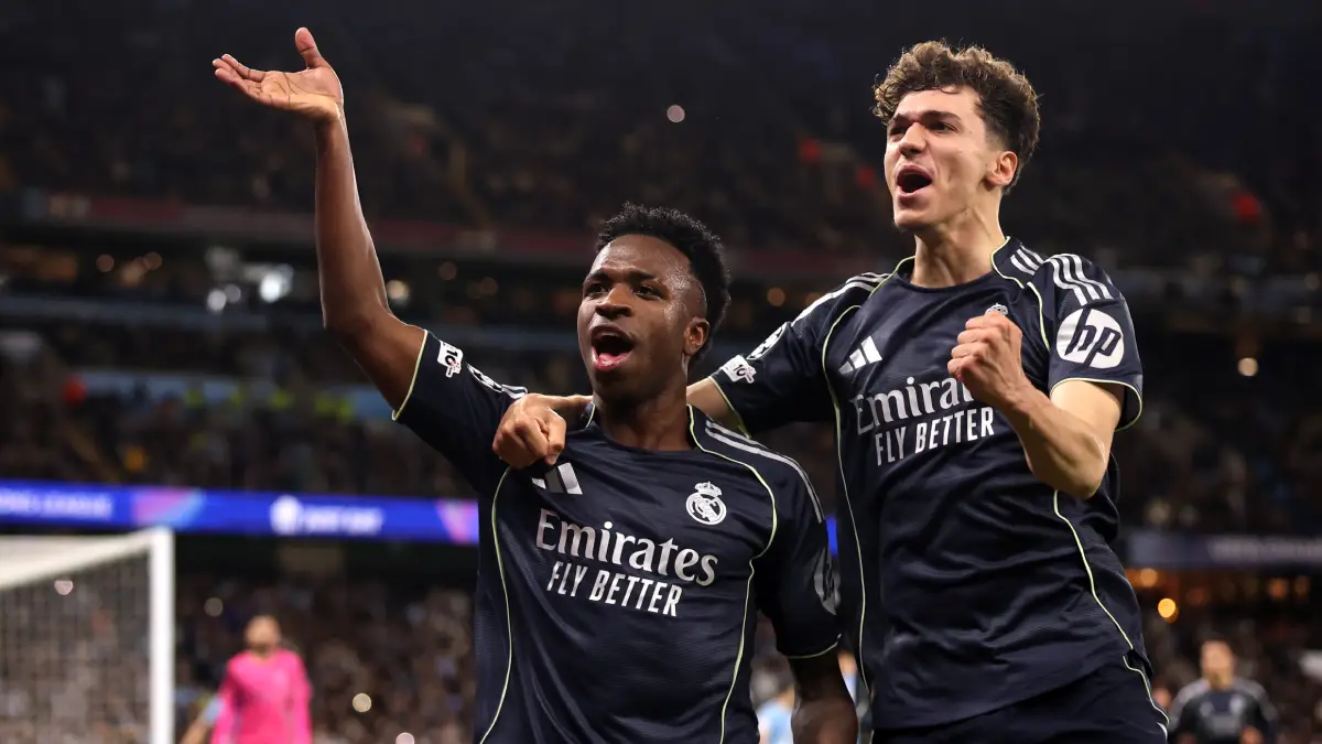 MANCHESTER, ENGLAND - MARCH 17: Vinicius Junior of Real Madrid celebrates scoring his team's first goal from the penalty spot with teammate Thiago Pitarch during the UEFA Champions League 2025/26 Round of 16 Second Leg match between Manchester City FC and Real Madrid CF at City of Manchester Stadium on March 17, 2026 in Manchester, England. (Photo by Carl Recine/Getty Images)