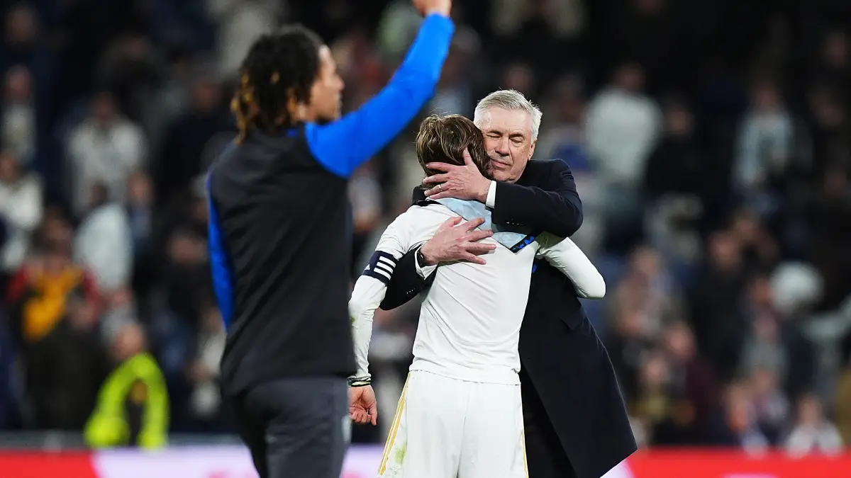 MADRID, SPAIN - FEBRUARY 25: Luka Modric of Real Madrid is embraced by Carlo Ancelotti, Head Coach of Real Madrid, after the team's victory in the LaLiga EA Sports match between Real Madrid CF and Sevilla FC at Estadio Santiago Bernabeu on February 25, 2024 in Madrid, Spain. (Photo by Angel Martinez/Getty Images)