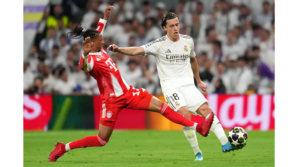 MADRID, SPAIN - APRIL 07: Alvaro Carreras of Real Madrid is challenged by Michael Olise of FC Bayern Munich during the UEFA Champions League 2025/26 Quarter-Final First Leg match between Real Madrid CF and FC Bayern München at Estadio Santiago Bernabeu on April 07, 2026 in Madrid, Spain. (Photo by Aitor Alcalde/Getty Images)