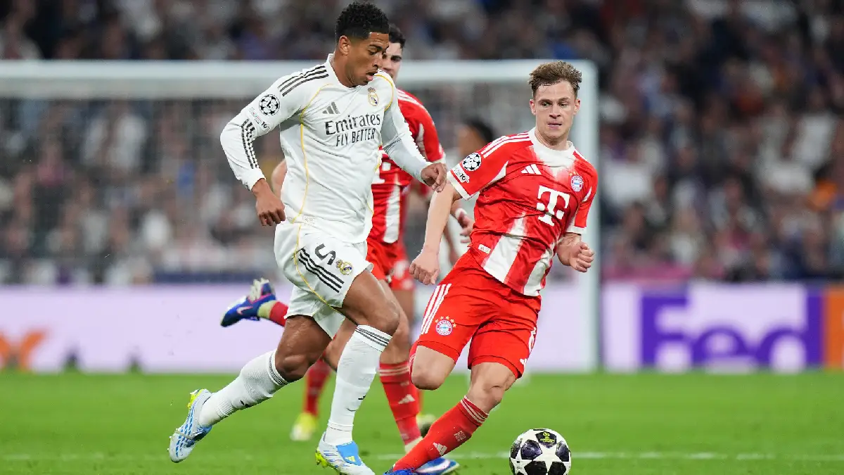 MADRID, SPAIN - APRIL 07: Jude Bellingham of Real Madrid runs with the ball while under pressure from Joshua Kimmich of FC Bayern Munich during the UEFA Champions League 2025/26 Quarter-Final First Leg match between Real Madrid CF and FC Bayern München at Estadio Santiago Bernabeu on April 07, 2026 in Madrid, Spain. (Photo by Angel Martinez/Getty Images)