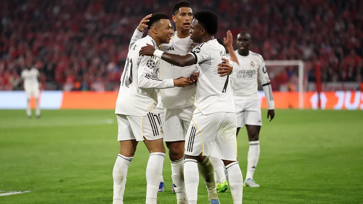 MUNICH, GERMANY - APRIL 15: Kylian Mbappe of Real Madrid celebrates scoring his team's third goal with teammates Jude Bellingham and Vinicius Junior during the UEFA Champions League 2025/26 Quarter-Final Second Leg match between FC Bayern München and Real Madrid CF at Football Arena Munich on April 15, 2026 in Munich, Germany. (Photo by Adam Pretty/Getty Images)