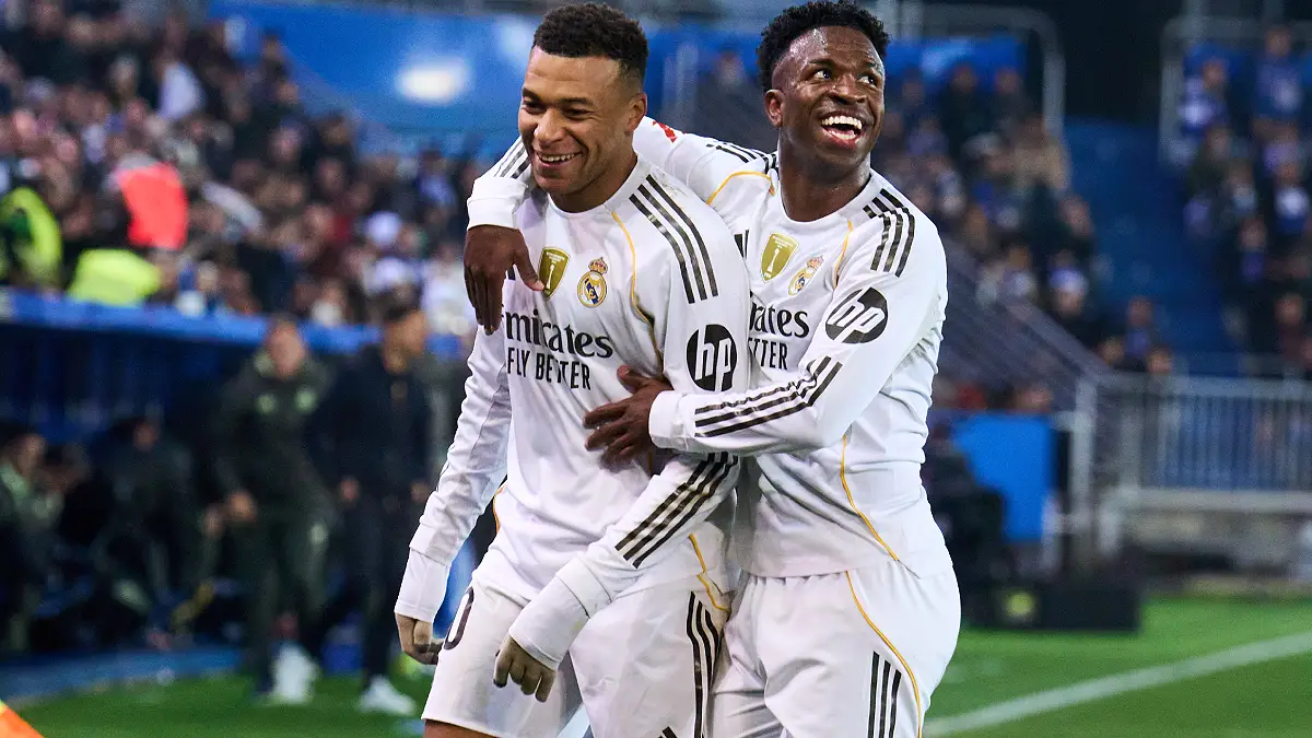 VITORIA-GASTEIZ, SPAIN - DECEMBER 14: Kylian Mbappe of Real Madrid celebrates scoring his team's first goal with teammate Vinicius Junior during the LaLiga EA Sports match between Deportivo Alaves and Real Madrid CF at Estadio de Mendizorroza on December 14, 2025 in Vitoria-Gasteiz, Spain. (Photo by Juan Manuel Serrano Arce/Getty Images)