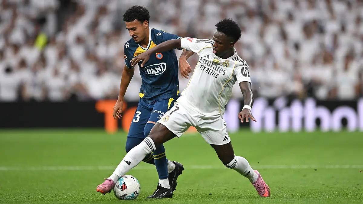 MADRID, SPAIN - SEPTEMBER 20: Vinicius Junior of Real Madrid tackles Omar El Hilali of RCD Espanyol during the LaLiga EA Sports match between Real Madrid CF and RCD Espanyol de Barcelona at Estadio Santiago Bernabeu on September 20, 2025 in Madrid, Spain. (Photo by Denis Doyle/Getty Images)