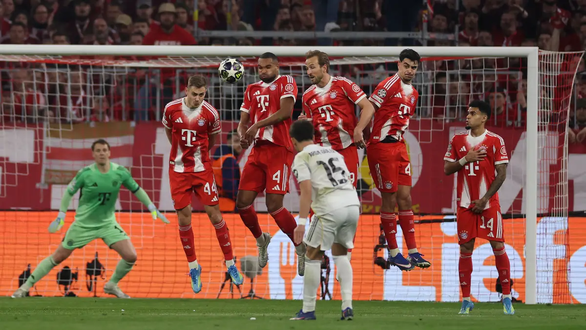 MUNICH, GERMANY - APRIL 15: Josip Stanisic, Jonathan Tah, Harry Kane, Aleksandar Pavlovic and Luis Diaz of FC Bayern Munich fail to block a free kick scored by Arda Guler of Real Madrid, resulting in Real Madrid's second goal during the UEFA Champions League 2025/26 Quarter-Final Second Leg match between FC Bayern München and Real Madrid CF at Football Arena Munich on April 15, 2026 in Munich, Germany. (Photo by Lars Baron/Getty Images)