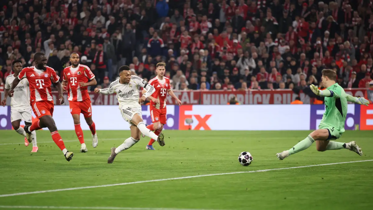 MUNICH, GERMANY - APRIL 15: Kylian Mbappe of Real Madrid scores his team's third goal past Manuel Neuer of FC Bayern Munich during the UEFA Champions League 2025/26 Quarter-Final Second Leg match between FC Bayern München and Real Madrid CF at Football Arena Munich on April 15, 2026 in Munich, Germany. (Photo by Alex Grimm/Getty Images)
