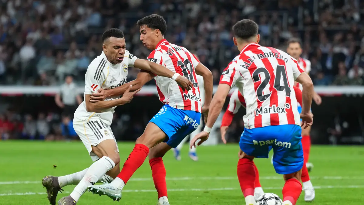 MADRID, SPAIN - APRIL 10: Kylian Mbappe of Real Madrid is challenged by Vitor Reis of Girona FC during the LaLiga EA Sports match between Real Madrid CF and Girona FC at Estadio Santiago Bernabeu on April 10, 2026 in Madrid, Spain. (Photo by Angel Martinez/Getty Images)