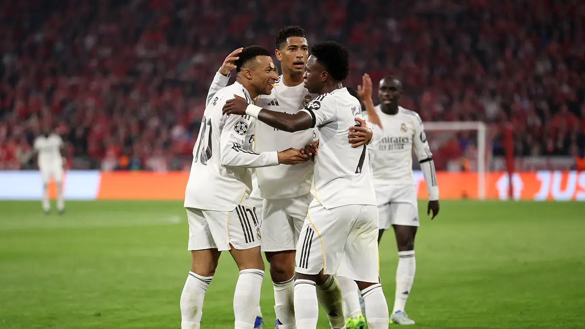 MUNICH, GERMANY - APRIL 15: Kylian Mbappe of Real Madrid celebrates scoring his team's third goal with teammates Jude Bellingham and Vinicius Junior during the UEFA Champions League 2025/26 Quarter-Final Second Leg match between FC Bayern München and Real Madrid CF at Football Arena Munich on April 15, 2026 in Munich, Germany. (Photo by Adam Pretty/Getty Images)