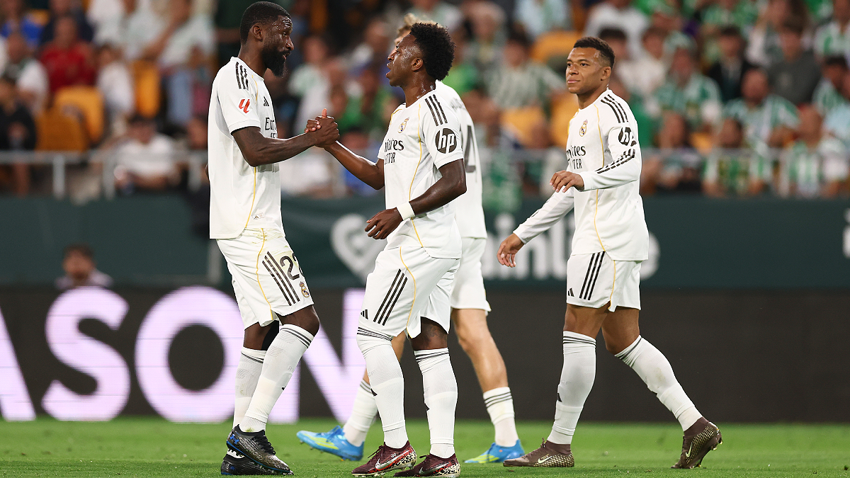 SEVILLE, SPAIN - APRIL 24: Vinicius Junior of Real Madrid celebrates scoring his team's first goal with teammate Antonio Ruediger during the LaLiga EA Sports match between Real Betis Balompie and Real Madrid CF at Estadio La Cartuja on April 24, 2026 in Seville, Spain. (Photo by Fran Santiago/Getty Images)
