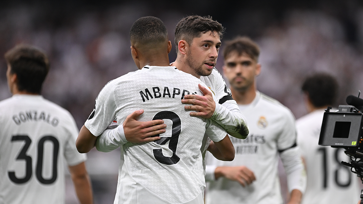 MADRID, SPAIN - MAY 24: Kylian Mbappe of Real Madrid is embraced by teammate Federico Valverde after scoring Real's second goal during the LaLiga match between Real Madrid CF and Real Sociedad at Estadio Santiago Bernabeu on May 24, 2025 in Madrid, Spain. (Photo by Denis Doyle/Getty Images)