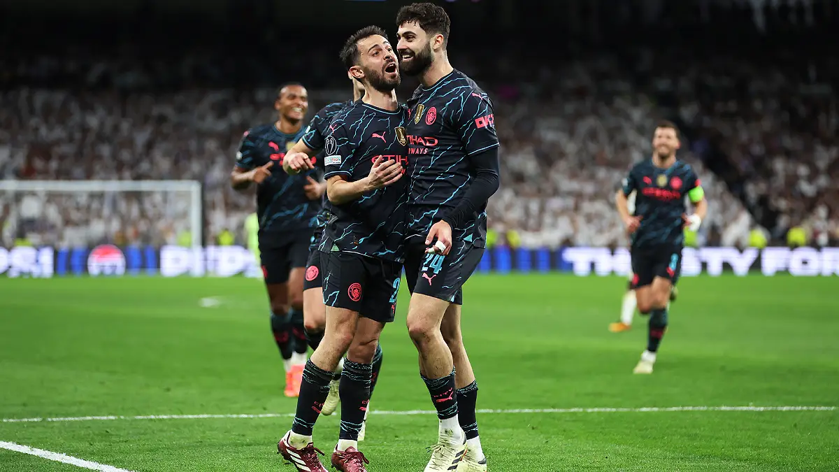 MADRID, SPAIN - APRIL 09: Josko Gvardiol of Manchester City celebrates scoring his team's third goal with teammate Bernardo Silva during the UEFA Champions League quarter-final first leg match between Real Madrid CF and Manchester City at Estadio Santiago Bernabeu on April 09, 2024 in Madrid, Spain. (Photo by Clive Brunskill/Getty Images)