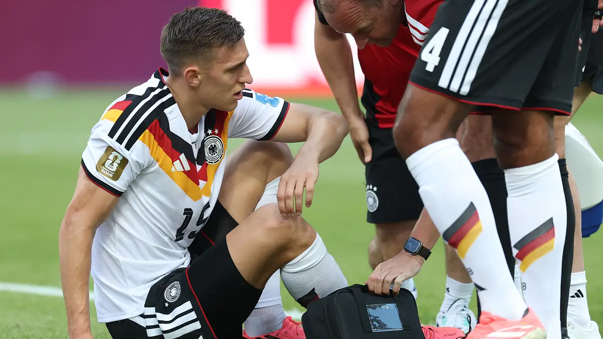 TORONTO, ONTARIO - JUNE 20: Nico Schlotterbeck #15 of Germany receives medical attention during the FIFA World Cup 2026 Group E match between Germany and Cote D'Ivoire at Toronto Stadium on June 20, 2026 in Toronto, Ontario. (Photo by Alexander Hassenstein/Getty Images)