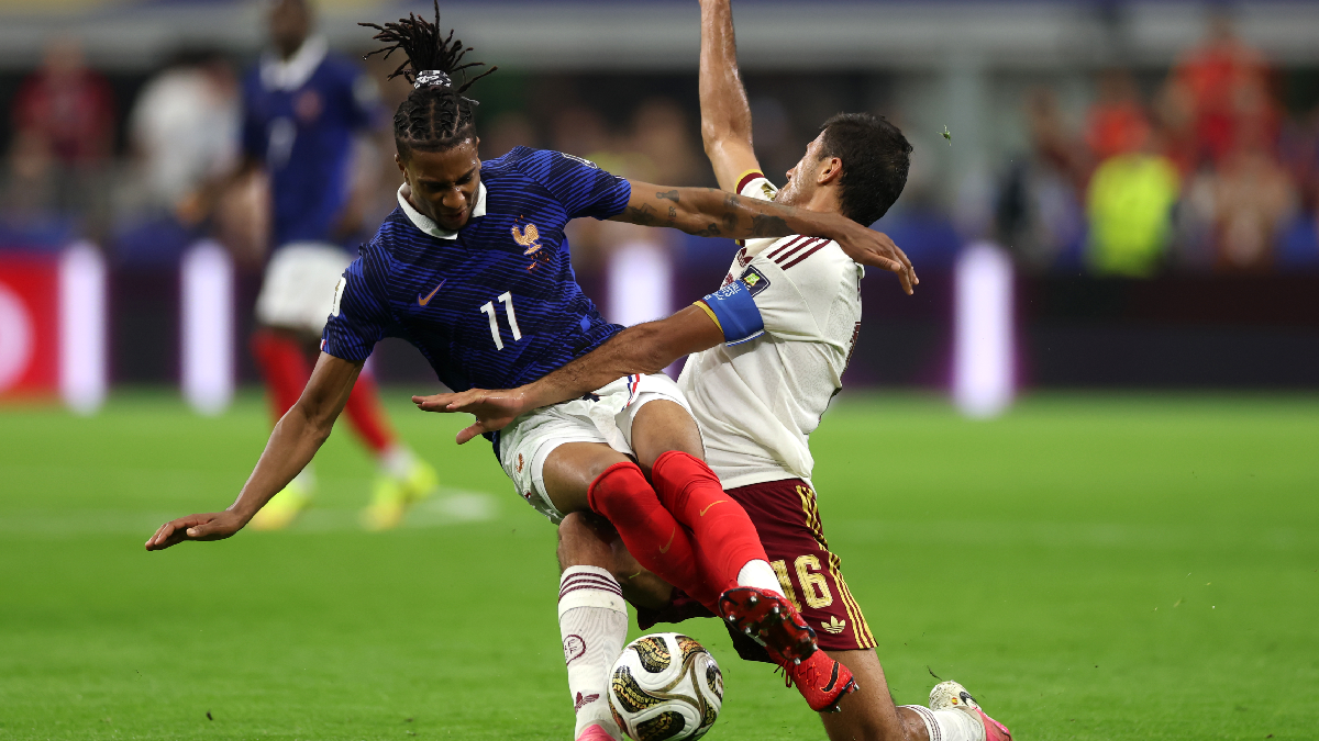 ARLINGTON, TEXAS - JULY 14: Michael Olise #11 of France competes for the ball against Rodri #16 of Spain during the FIFA World Cup 2026 Semi Final match between France and Spain at Dallas Stadium on July 14, 2026 in Arlington, Texas. (Photo by Lars Baron/Getty Images)