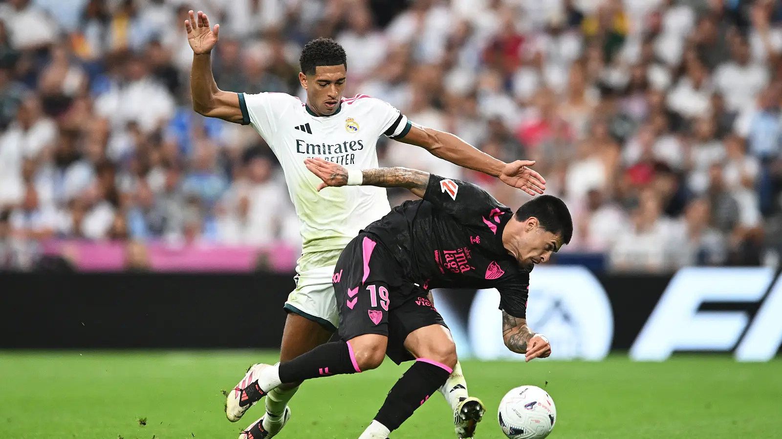 MADRID, SPAIN - AUGUST 30: Juan Cruz of Malaga is challenged by Jude Bellingham of Real Madrid during the LaLiga EA Sports 2026/27 match between Real Madrid and Malaga CF at Estadio Santiago Bernabeu on August 30, 2026 in Madrid, Spain. (Photo by Denis Doyle/Getty Images)