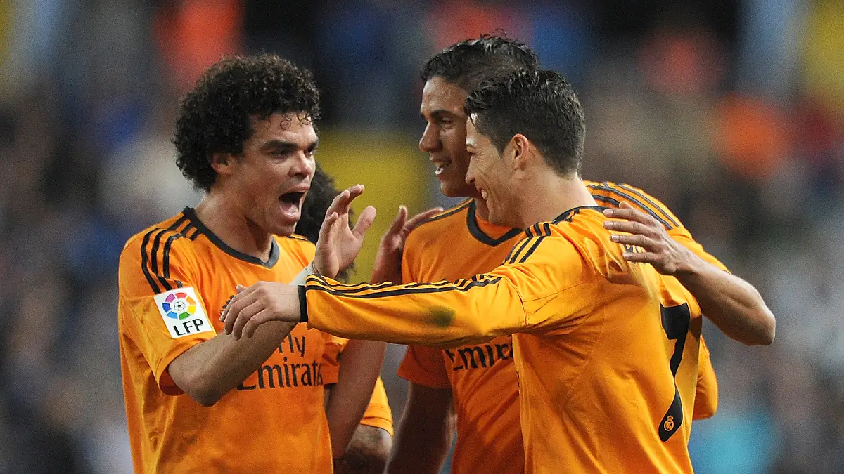 MALAGA, SPAIN - MARCH 15: Cristiano Ronaldo (R) of Real Madrid celebrates with Pepe (L) and Raphael Varane after scoring Real's opening goal during the La Liga match between Malaga and Real Madrid at La Rosaleda Stadium on March 15, 2014 in Malaga, Spain. (Photo by Denis Doyle/Getty Images)