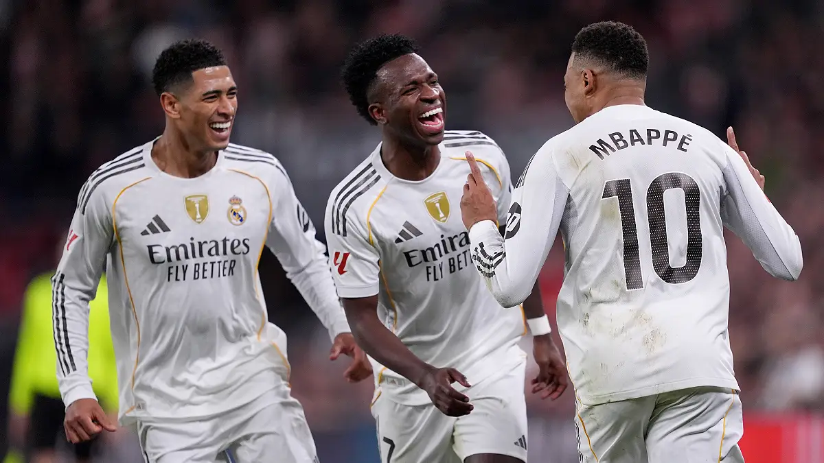 BILBAO, SPAIN - DECEMBER 03: Kylian Mbappe of Real Madrid celebrates scoring his team's third goal with teammates Vinicius Junior and Jude Bellingham during the LaLiga EA Sports match between Athletic Club and Real Madrid CF at Estadio de San Mames on December 03, 2025 in Bilbao, Spain. (Photo by Juan Manuel Serrano Arce/Getty Images)