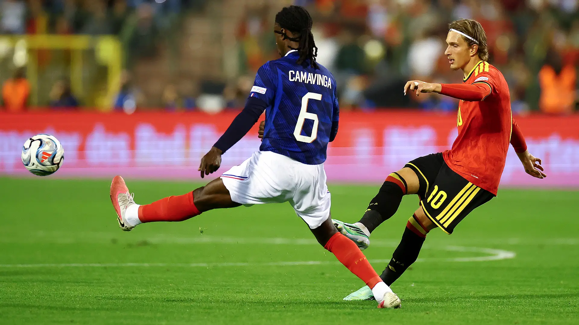 BRUSSELS, BELGIUM - SEPTEMBER 28: Mika Godts of Belgium passes the ball under pressure from Eduardo Camavinga of France during the UEFA Nations League 2026/27 group phase match between Belgium and France at Stade Roi Baudouin on September 28, 2026 in Brussels, Belgium. (Photo by Dean Mouhtaropoulos/Getty Images)
