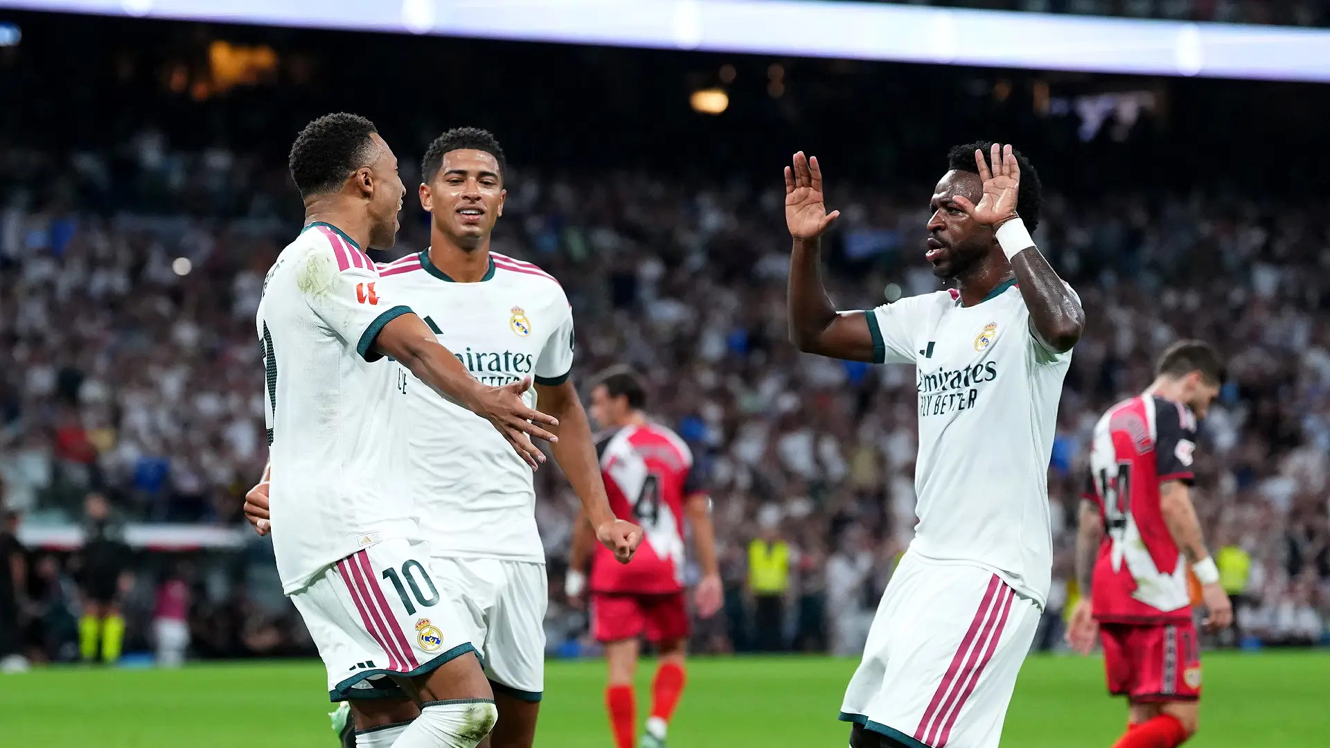 MADRID, SPAIN - SEPTEMBER 12: Kylian Mbappe of Real Madrid celebrates scoring his team’s first goal from the penalty spot, with teammates Jude Bellingham and Vinicius Junior during the LaLiga EA Sports 2026/27 match between Real Madrid and Rayo Vallecano de Madrid at Estadio Santiago Bernabeu on September 12, 2026 in Madrid, Spain. (Photo by Angel Martinez/Getty Images)