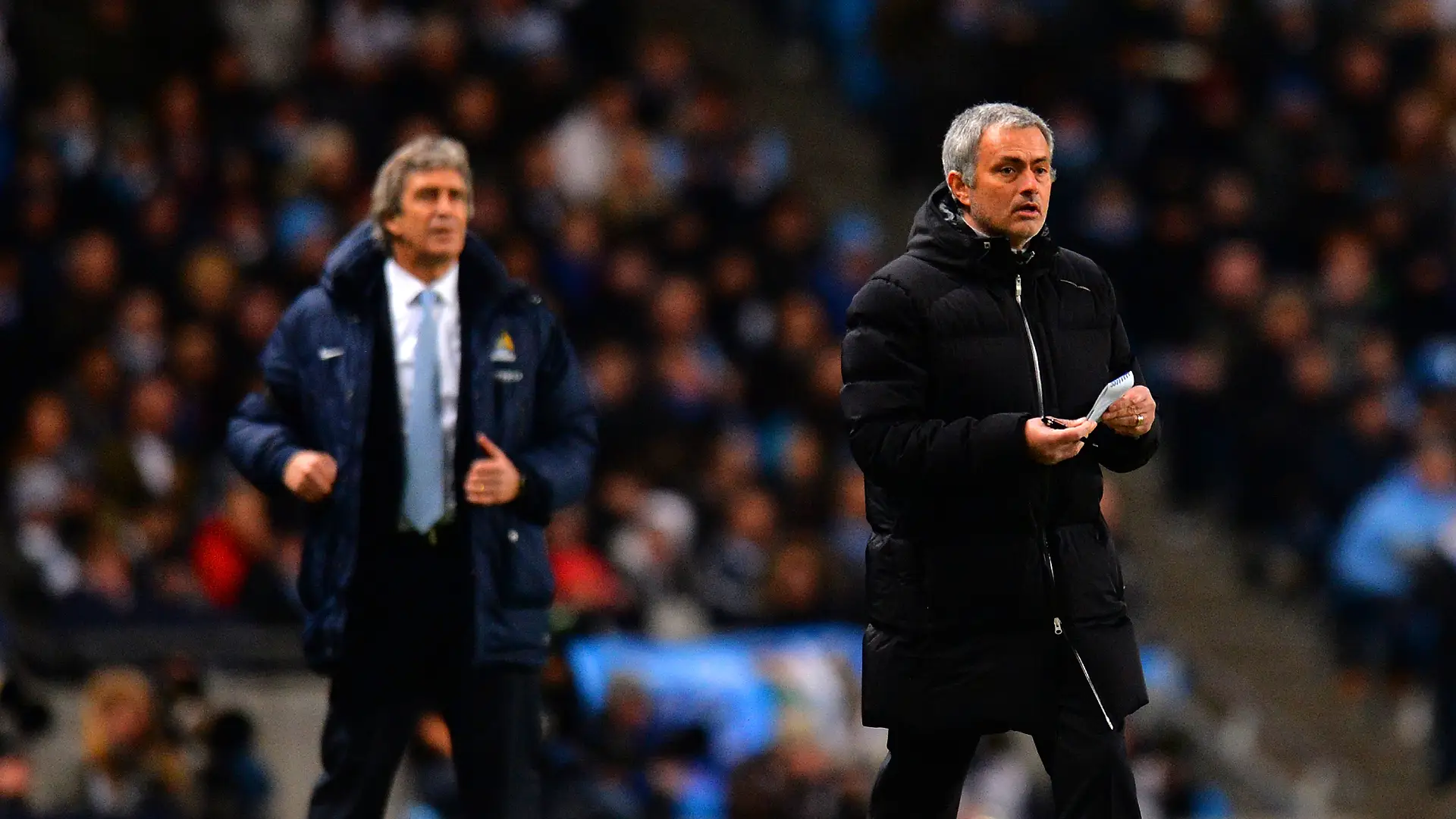 MANCHESTER, ENGLAND - FEBRUARY 03: Manuel Pellegrini manager of Manchester City and Jose Mourinho manager of Chelsea give instructions during the Barclays Premier League match between Manchester City and Chelsea at Etihad Stadium on February 3, 2014 in Manchester, England. (Photo by Shaun Botterill/Getty Images)